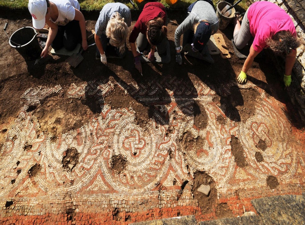 A group of volunteers uncovering the mosaic