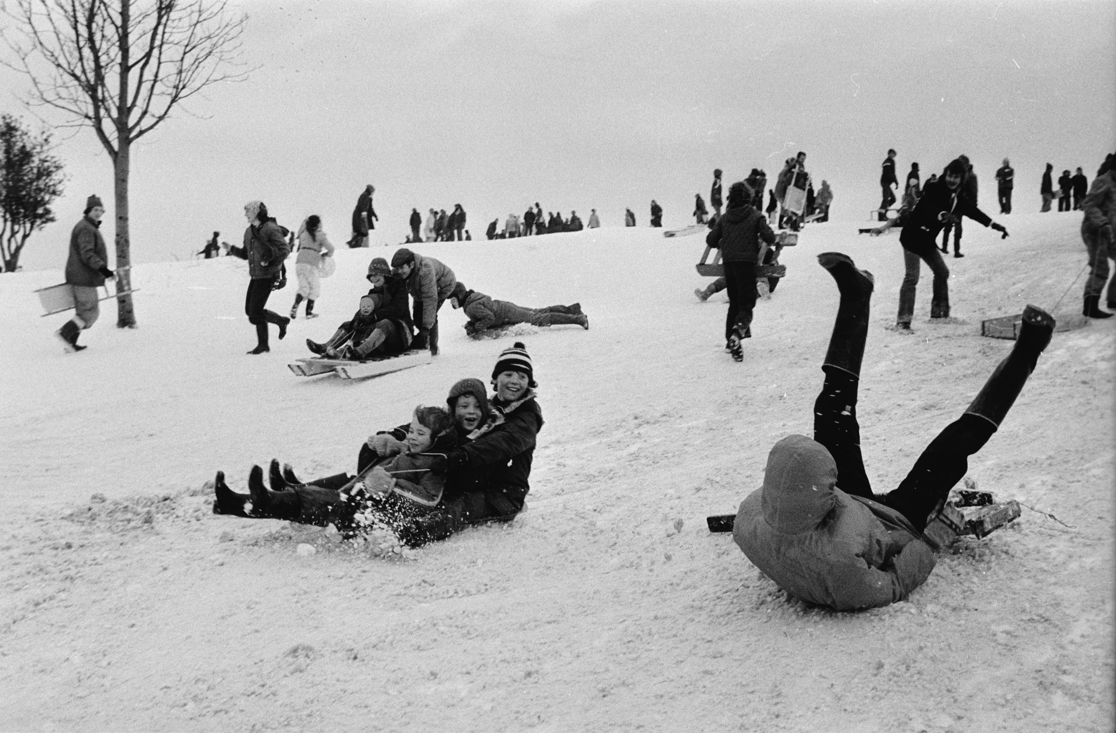 People cavort in the snow at Lyndhurst Hill, Southampton