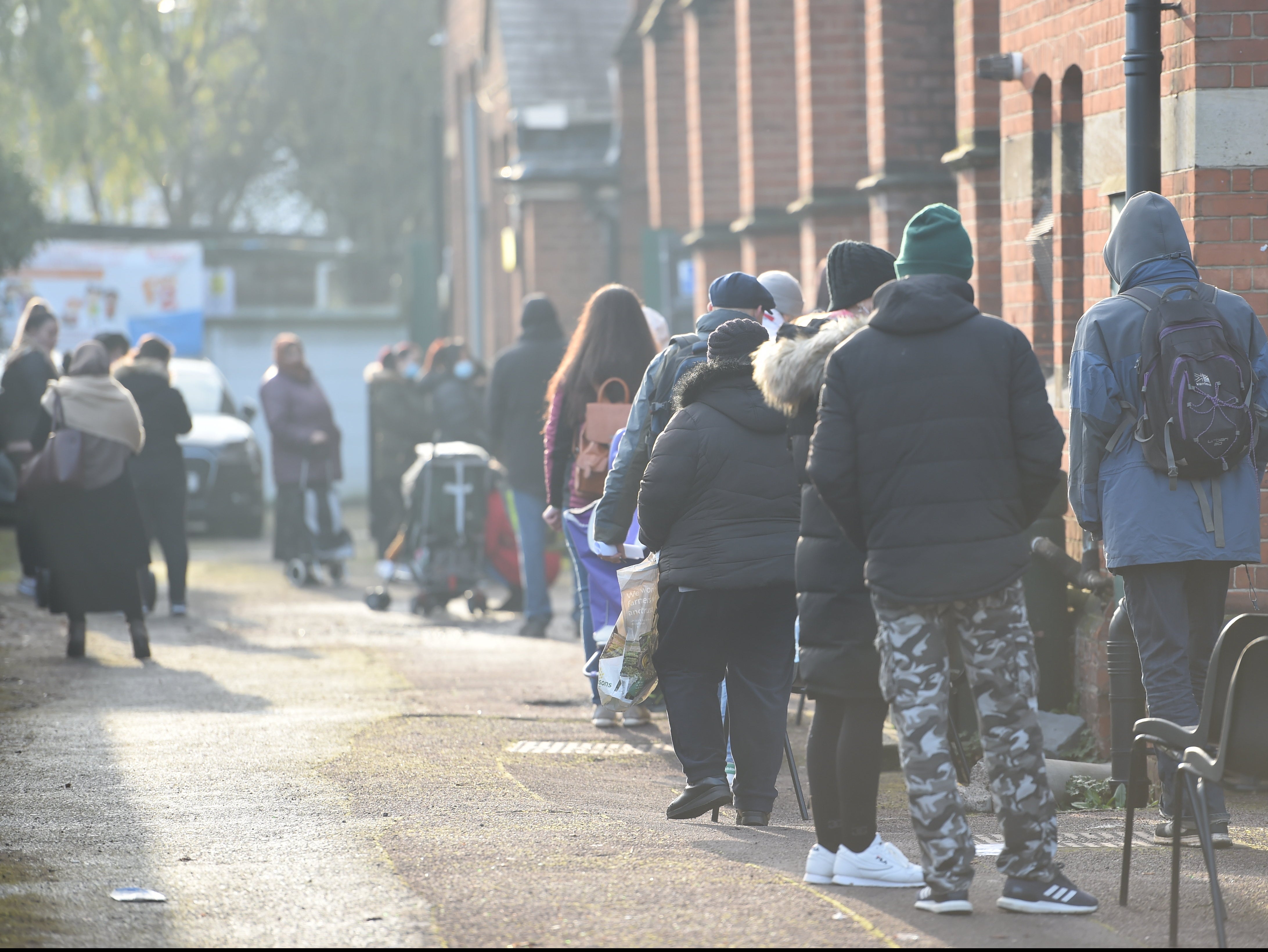 Service users queue at Green Lanes food bank in north London