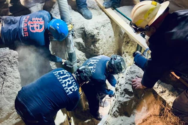 Firefighters attempting to rescue the boy from the well