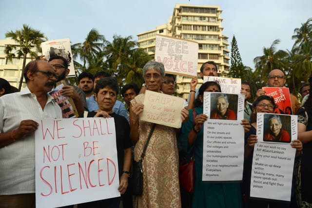 File Image: Indian protesters hold placards in a rally condemning the killing of journalist Gauri Lankesh, in Mumbai on September 6, 2017