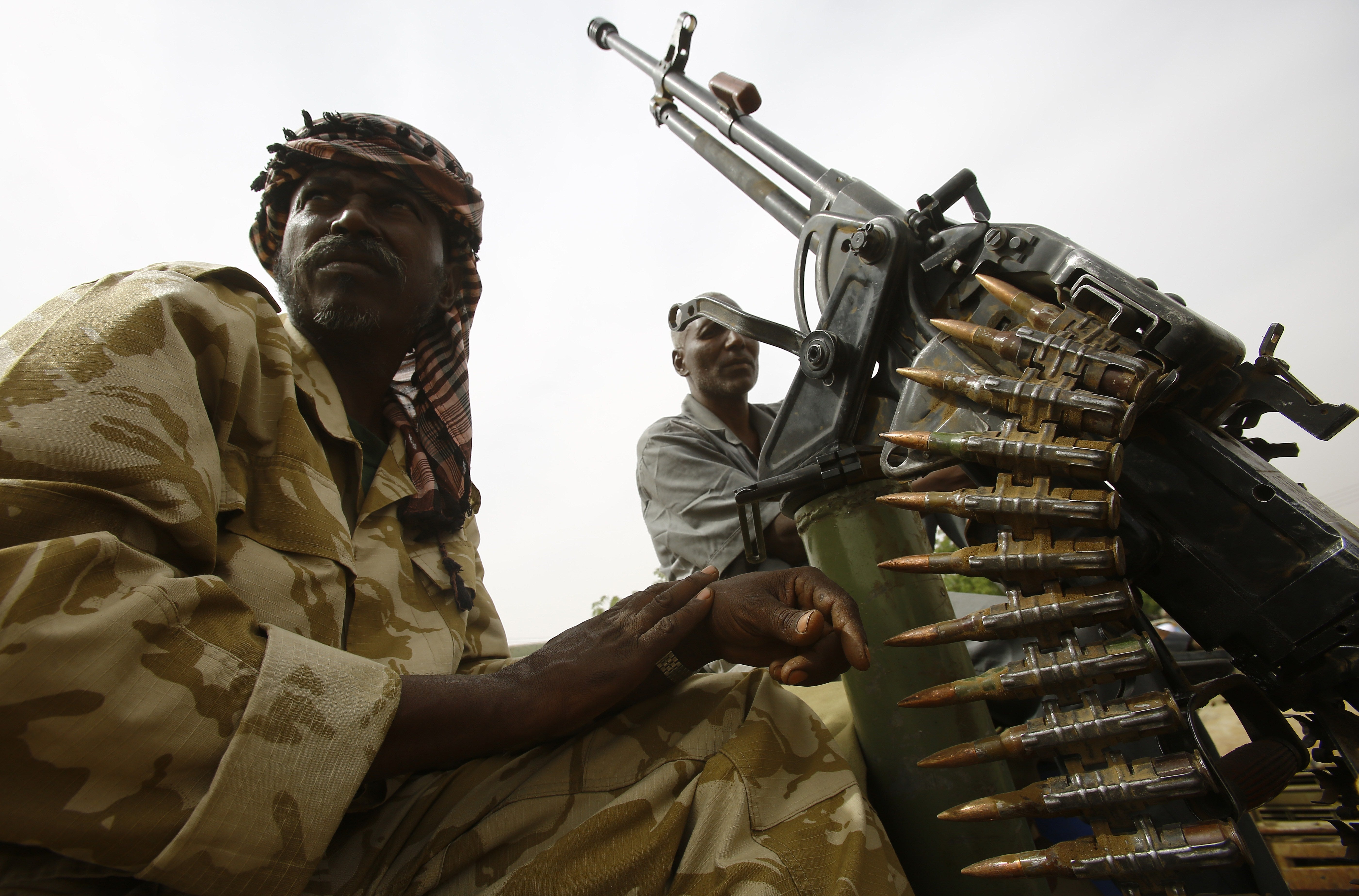 Fighters from the Sudanese Rapid Support Forces sit on an armed vehicle in the city of Nyala, in south Darfur, on May 3, 2015