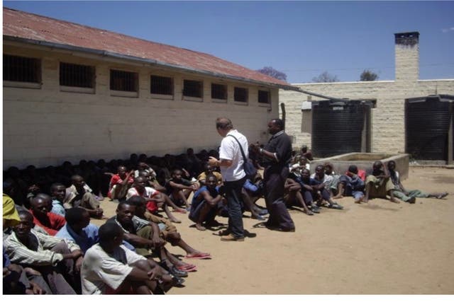 <p>Rev Paul Cowley MBE speaking to men in a high security prison in Kenya</p>