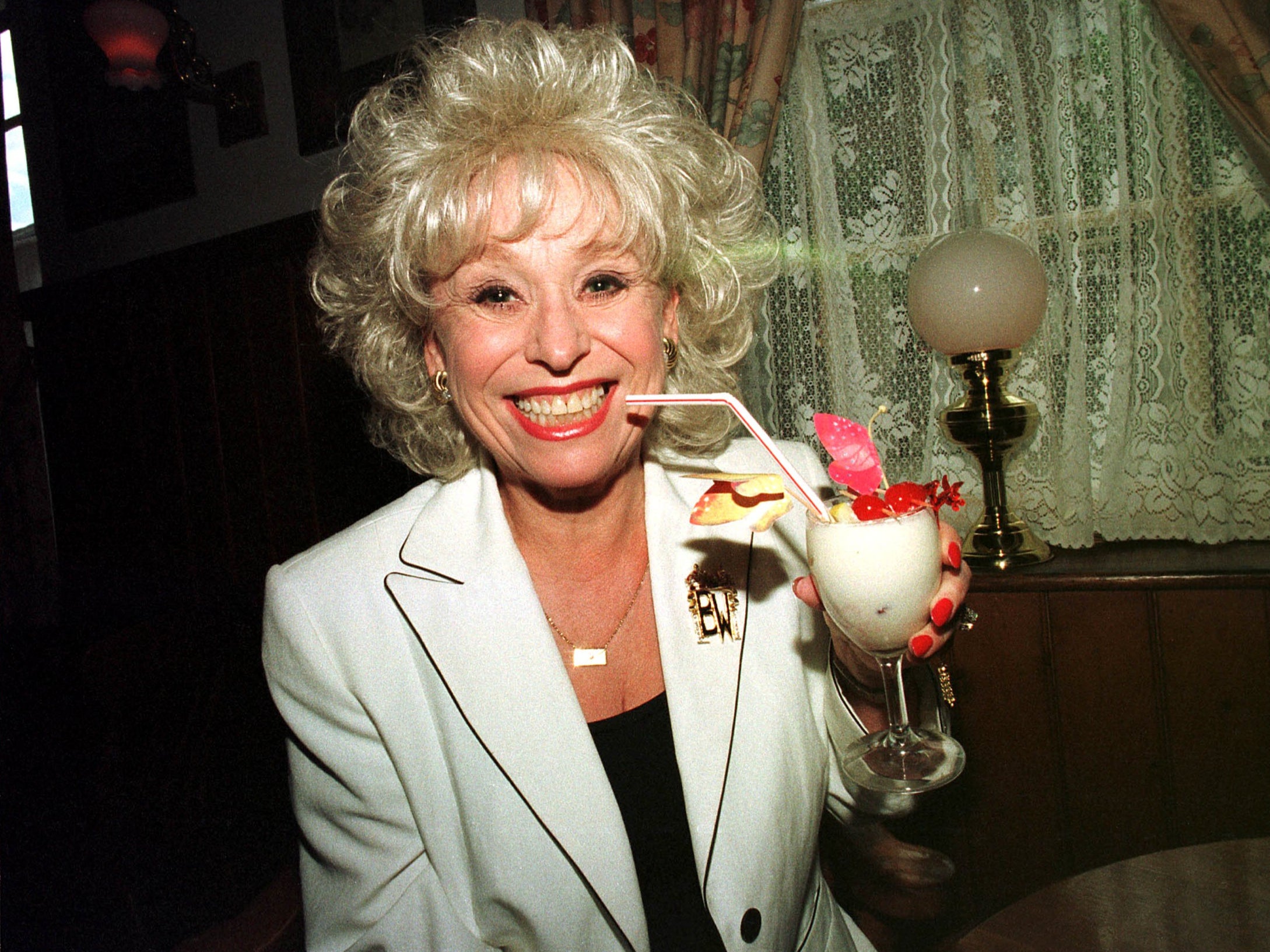 Barbara Windsor enjoys a cocktail at the White Hart Hotel in Essex, 1996