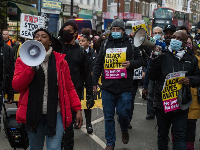 Anti-racists, community activists and school children attend a protest against police violence as they march from Park View School to Tottenham Police Station
