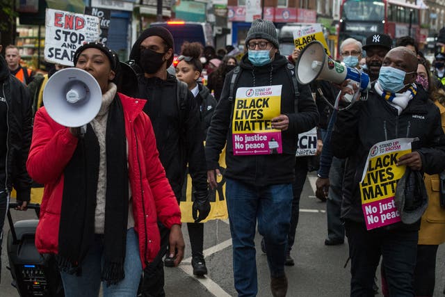 Anti-racists, community activists and school children attend a protest against police violence as they march from Park View School to Tottenham Police Station