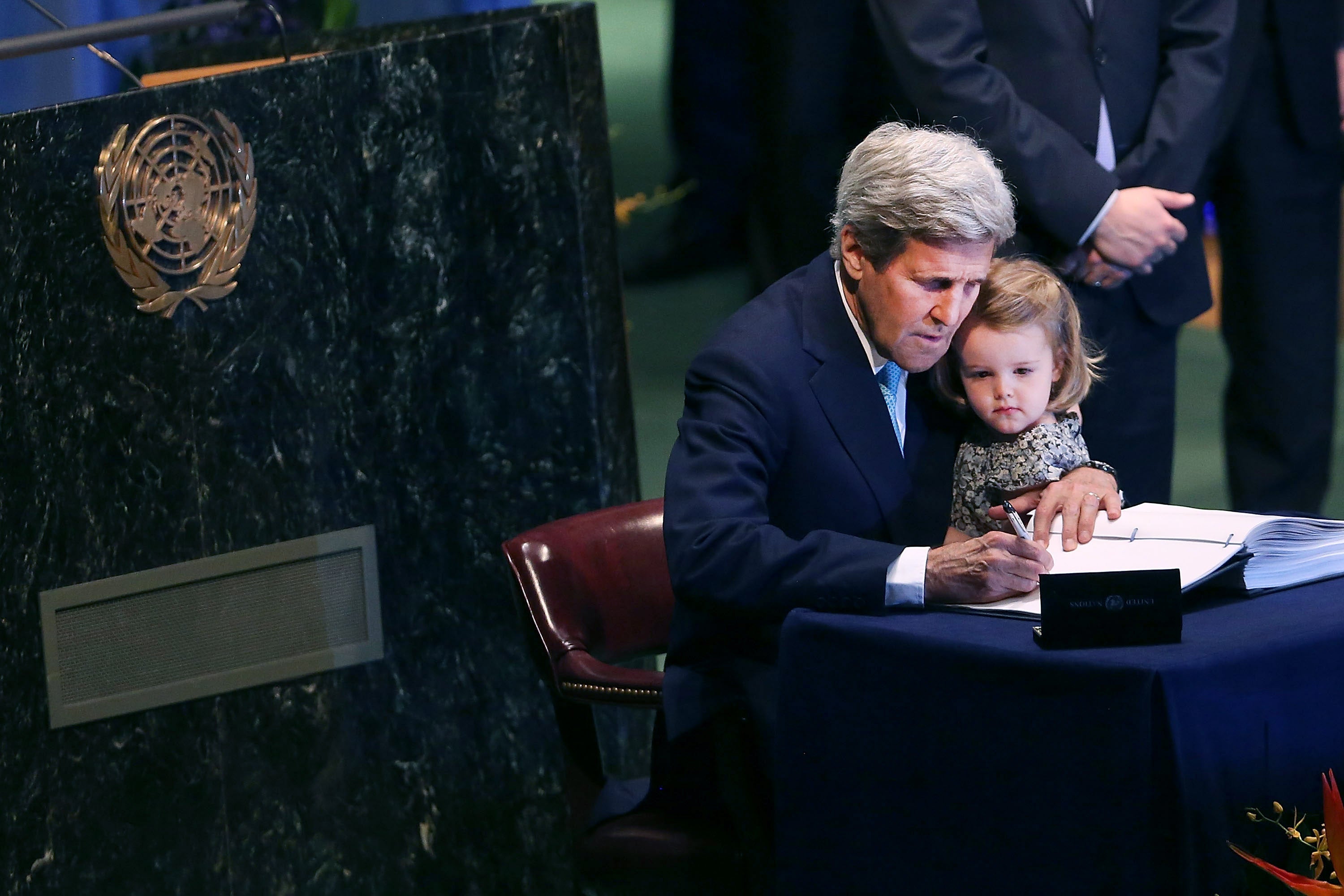 US Secretary of State John Kerry holds his two year-old grand daughter for the signing of the accord at the United Nations Signing Ceremony for the Paris Agreement climate change accord