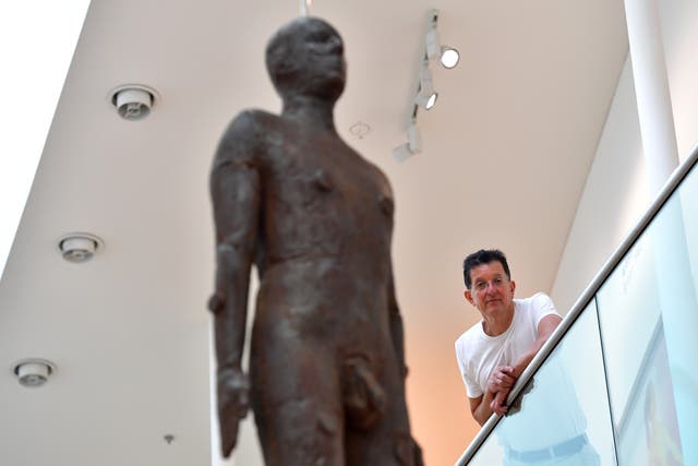 <p>Gormley with his artwork ‘Object, 199’, a life-size iron sculpture cast from the artist’s body and hung from the ceiling of the National Portrait Gallery in 2016</p>