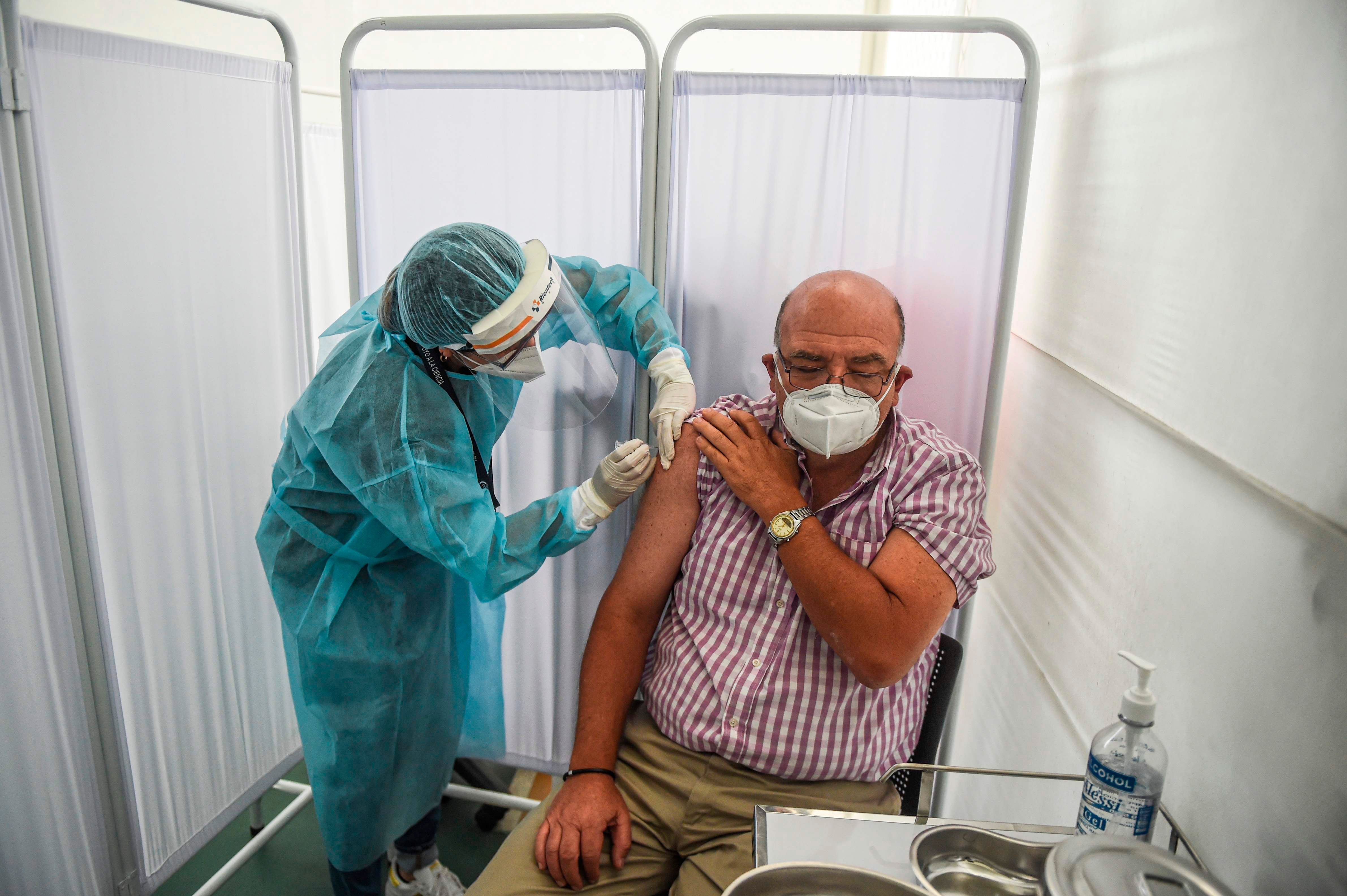 A health worker inoculates a volunteer with a Covid-19 vaccine developed by Sinopharm during its trial in Peru