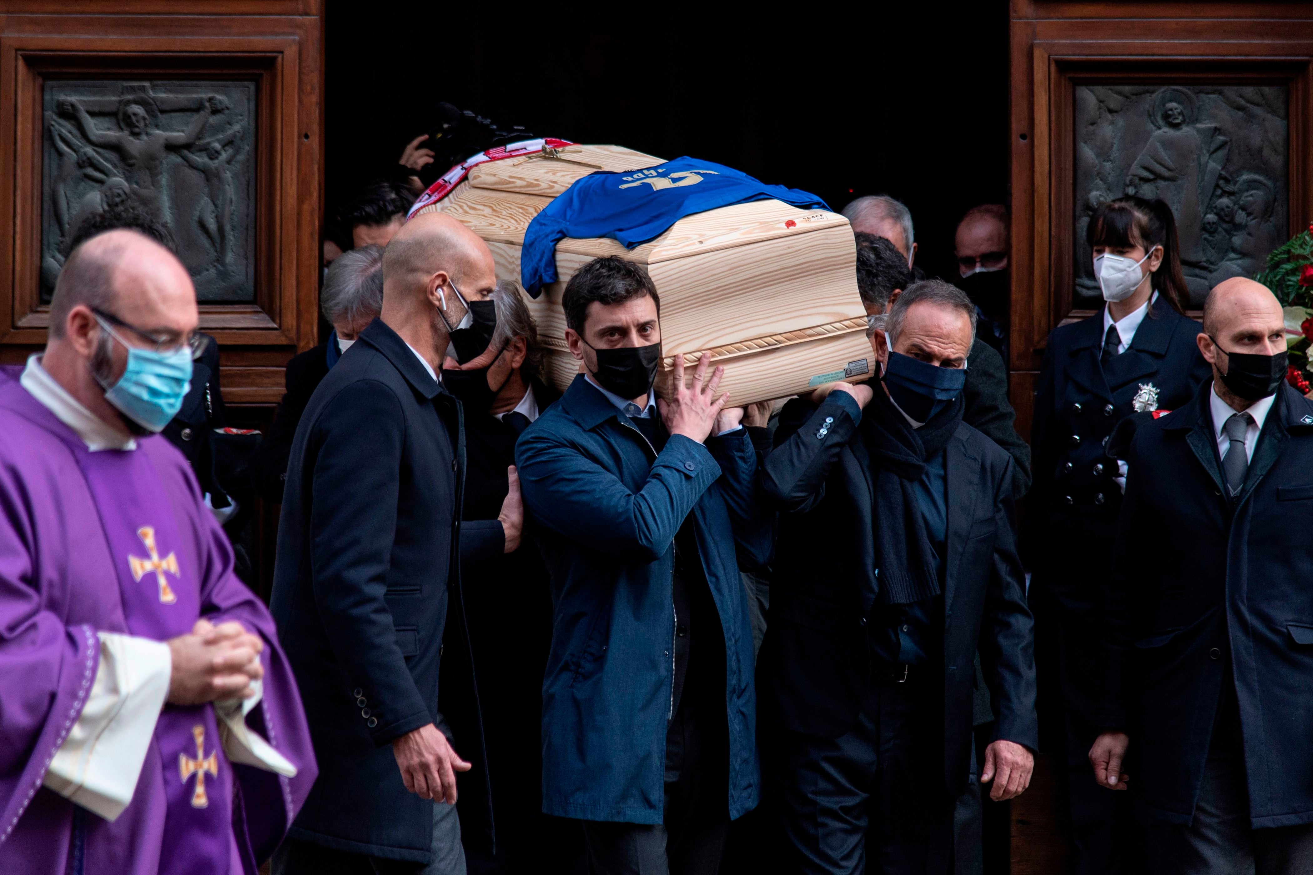 Italy’s former football player Antonio Cabrini (right) and the son of Paolo Rossi, Alessandro Rossi (left), carry the coffin of the late Italian football player during his funeral at the Santa Maria Annunciata Cathedral in Vicenza, northeastern Italy, on December 12, 2020. The footballer’s home was reportedly burgled while his family was away at the service.