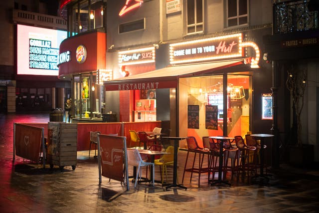 <p>Empty tables at a restaurant in Leicester Square, London</p>