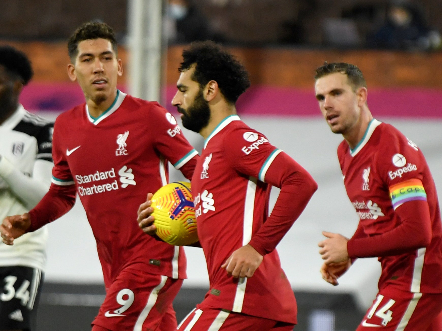 Mohamed Salah retrieves the ball after scoring the penalty
