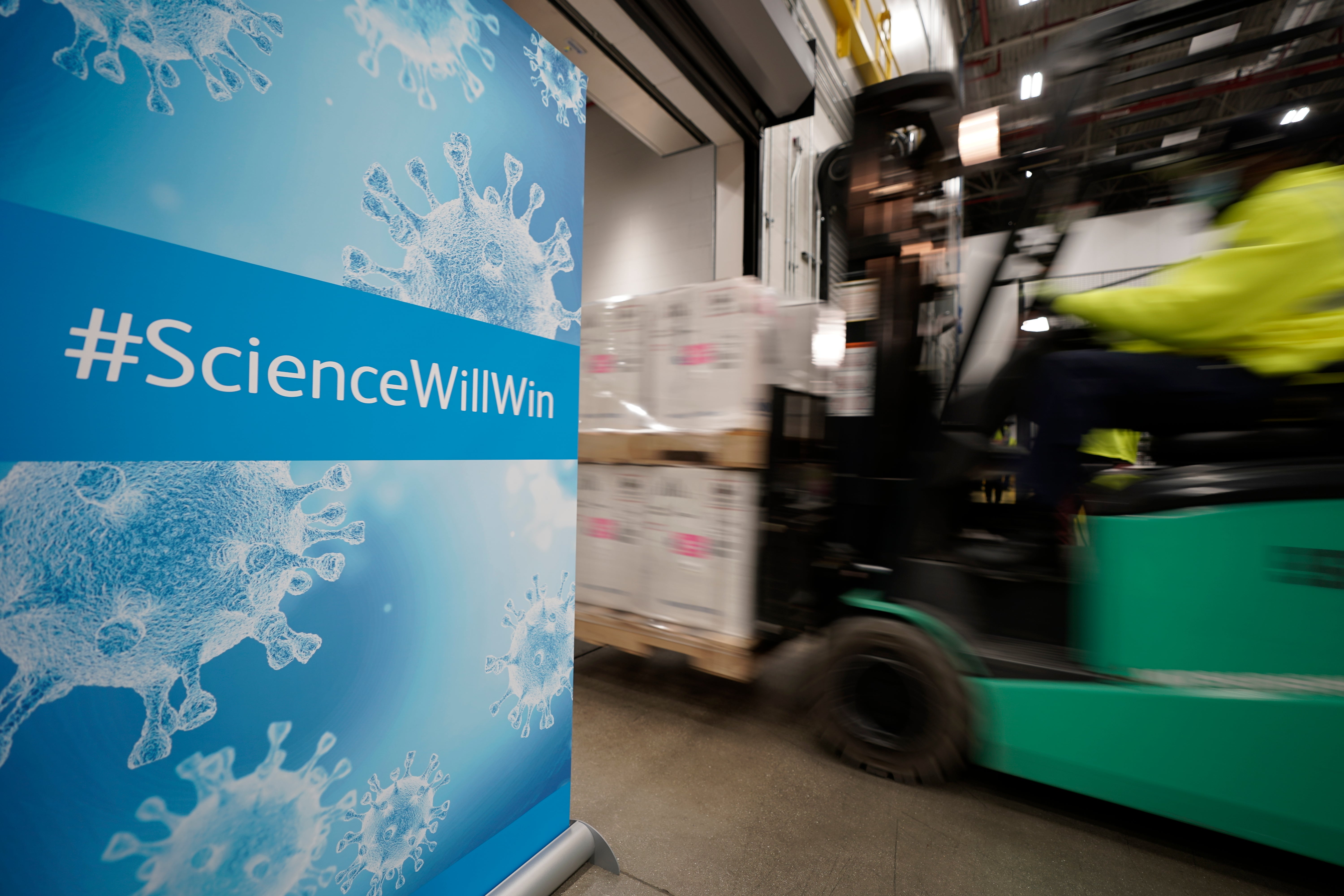 Boxes containing the Pfizer-BioNTech coronavirus vaccine are loaded onto a truck for shipping&nbsp;