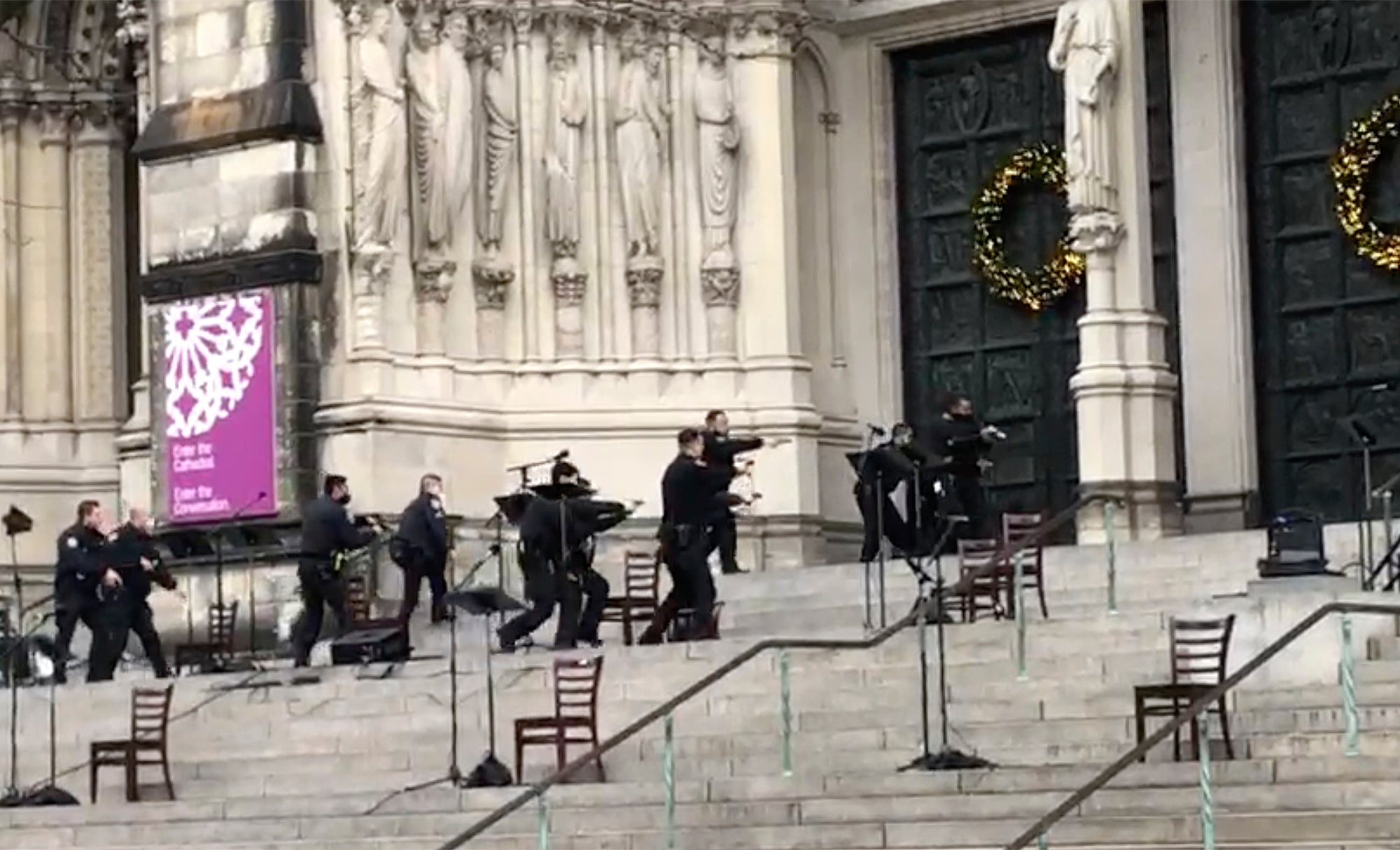 Man shot dead by police after firing semiautomatic handguns at end of Manhattan cathedral Christmas carol concert