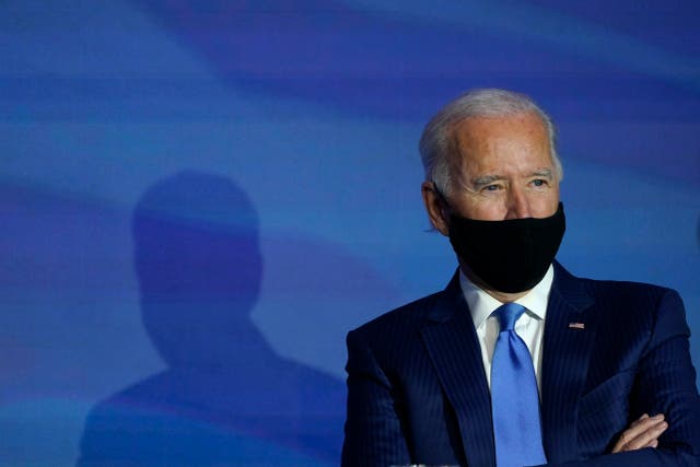 In this 11 December 2020, file photo President-elect Joe Biden listens during an event to announce his choice for several positions in his administration at The Queen theatre in Wilmington, Delaware