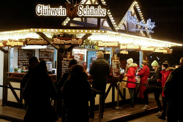<p>Local restaurant owners are offering hot mulled wine, or Gluhwein, from the steps of their shuttered eateries</p>