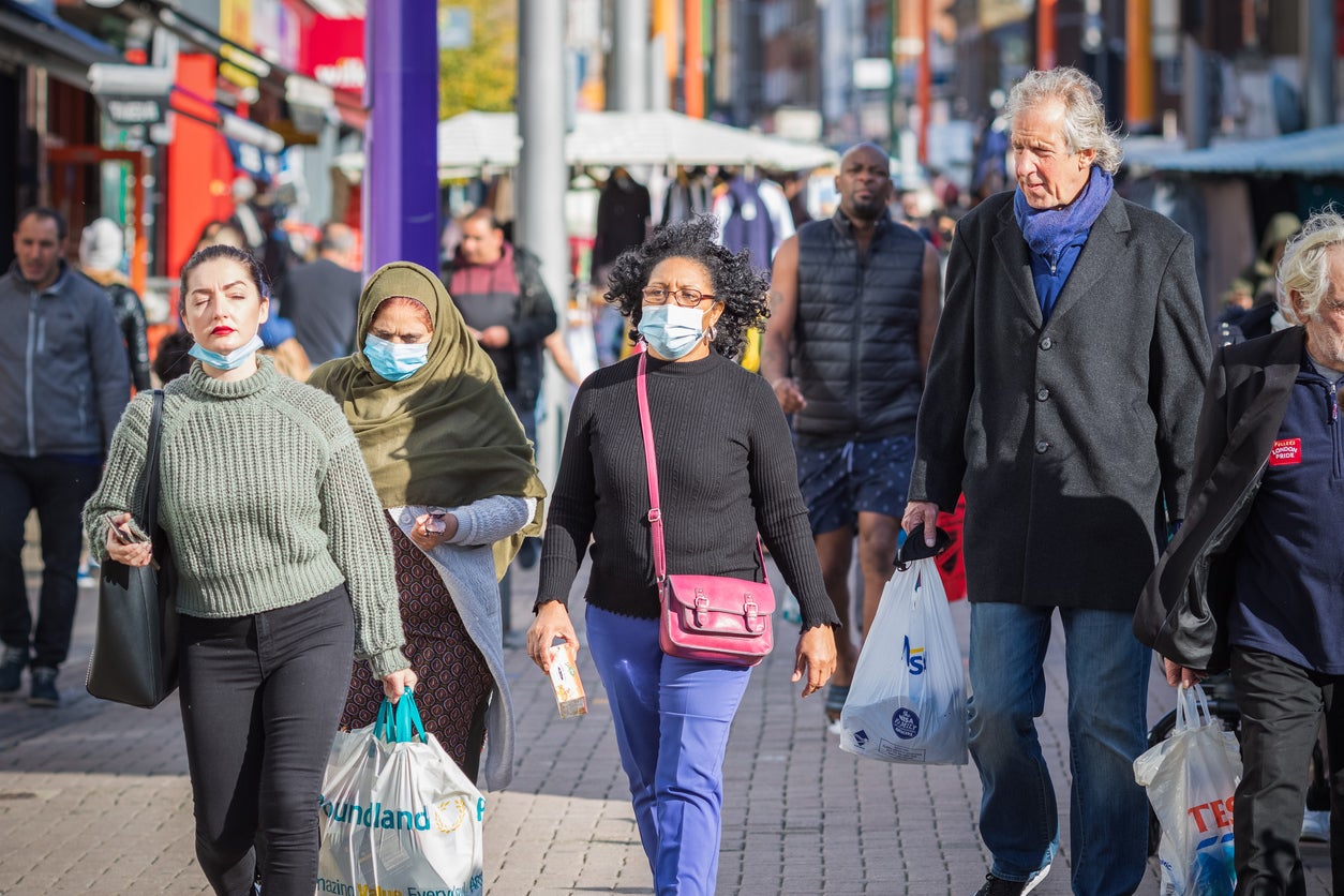 People wearing face masks while shopping at Walthamstow market in London