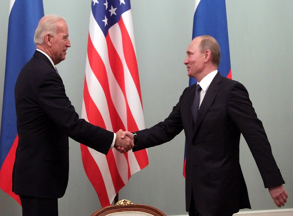 Then vice president Biden shakes hands with Putin during a meeting in Moscow in 2011