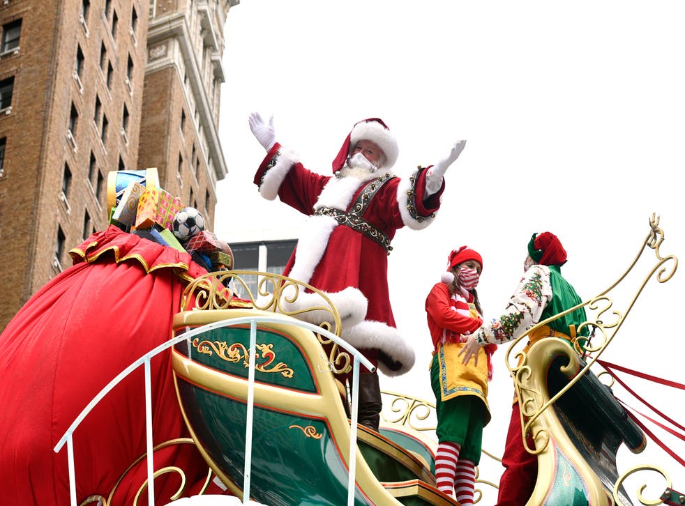 Santa Claus waves from his sleigh float at the 94th Annual Macy’s Thanksgiving Day Parade on 26 November, 2020 in New York City. A Santa in Belfast was pulled over by police on Monday, 14 December, 2020, after not having the right lights.