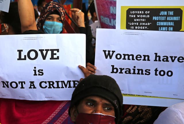 <p>File: People from different human rights organizations hold placards during a protest against the BJP over a so-called 'love <em>jihad</em>' law, in Bengaluru, India</p>
