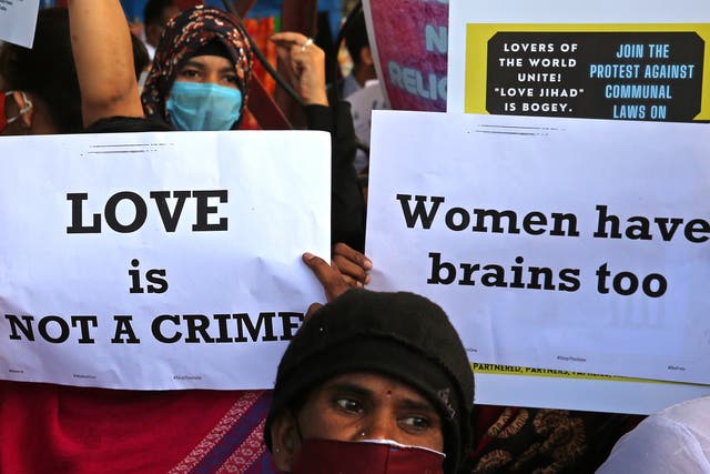 <p>File: People from different human rights organizations hold placards during a protest against the BJP over a so-called 'love <em>jihad</em>' law, in Bengaluru, India</p>