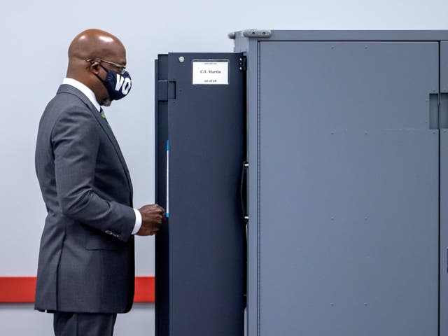 <p>Democratic US Senate candidate Raphael Warnock casts his ballot on the first day of voting in the Georgia runoffs</p>