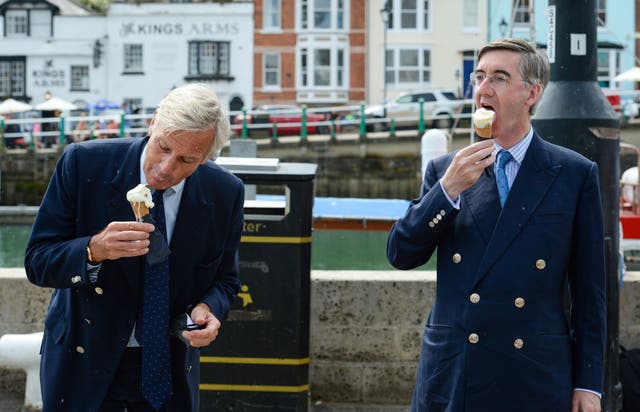 <p>Richard Drax MP (left) and Jacob Rees-Mogg eat an ice cream in Weymouth earlier this year</p>