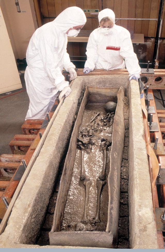 Conservators inspecting the skeleton of the Spitalfields Roman woman inside the lead coffin