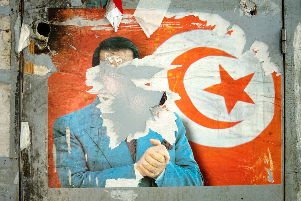 A torn poster of longtime Tunisian President Zine El Abidine Ben Ali who held the office from 1987 until he was forced to step down and flee the country after the Tunisian Revolution on 14 January 2011