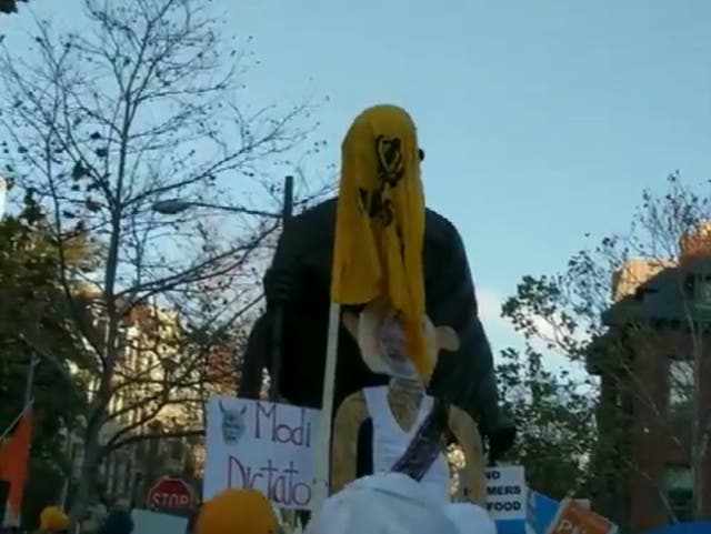 Placards and flags surround the Mahatma Gandhi statue in Washington DC amid protests against agricultural reforms