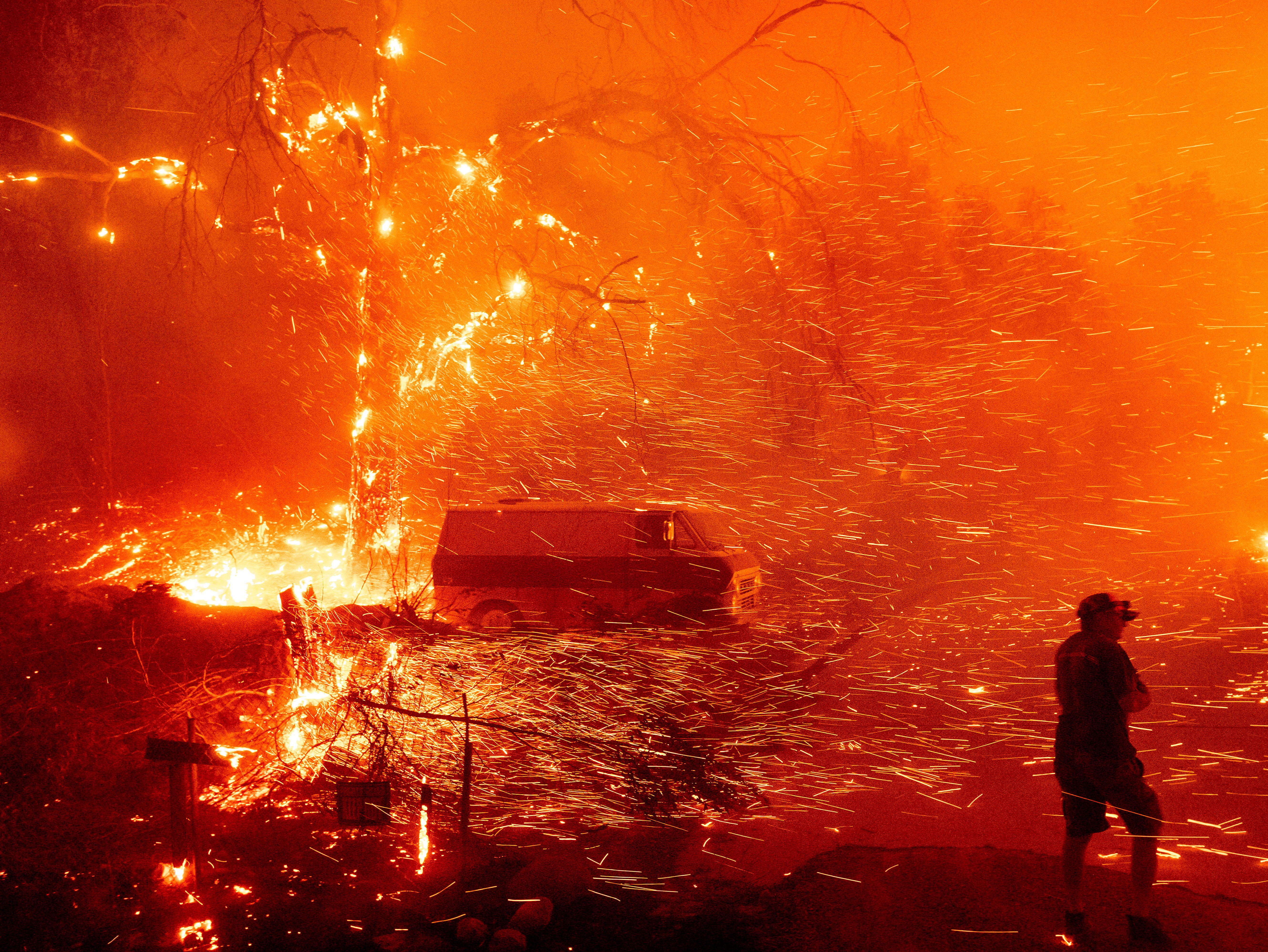 <p>Bruce McDougal prepares to defend his home as the Bond Fire burns though the Silverado community in Orange County, California, on 3 December 2020</p>