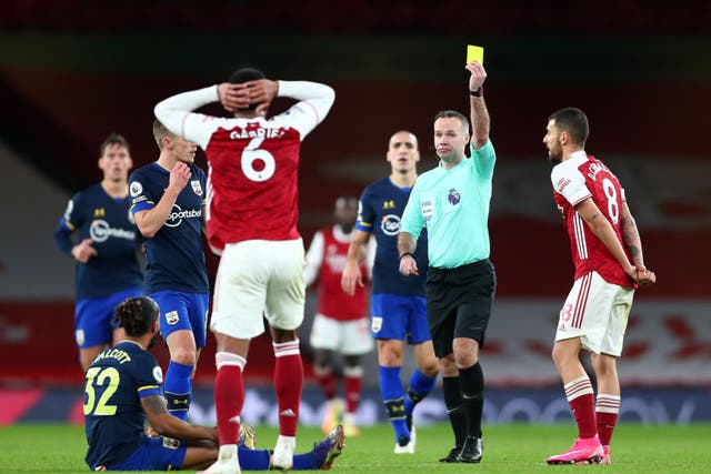 Gabriel of Arsenal is shown a second yellow card
