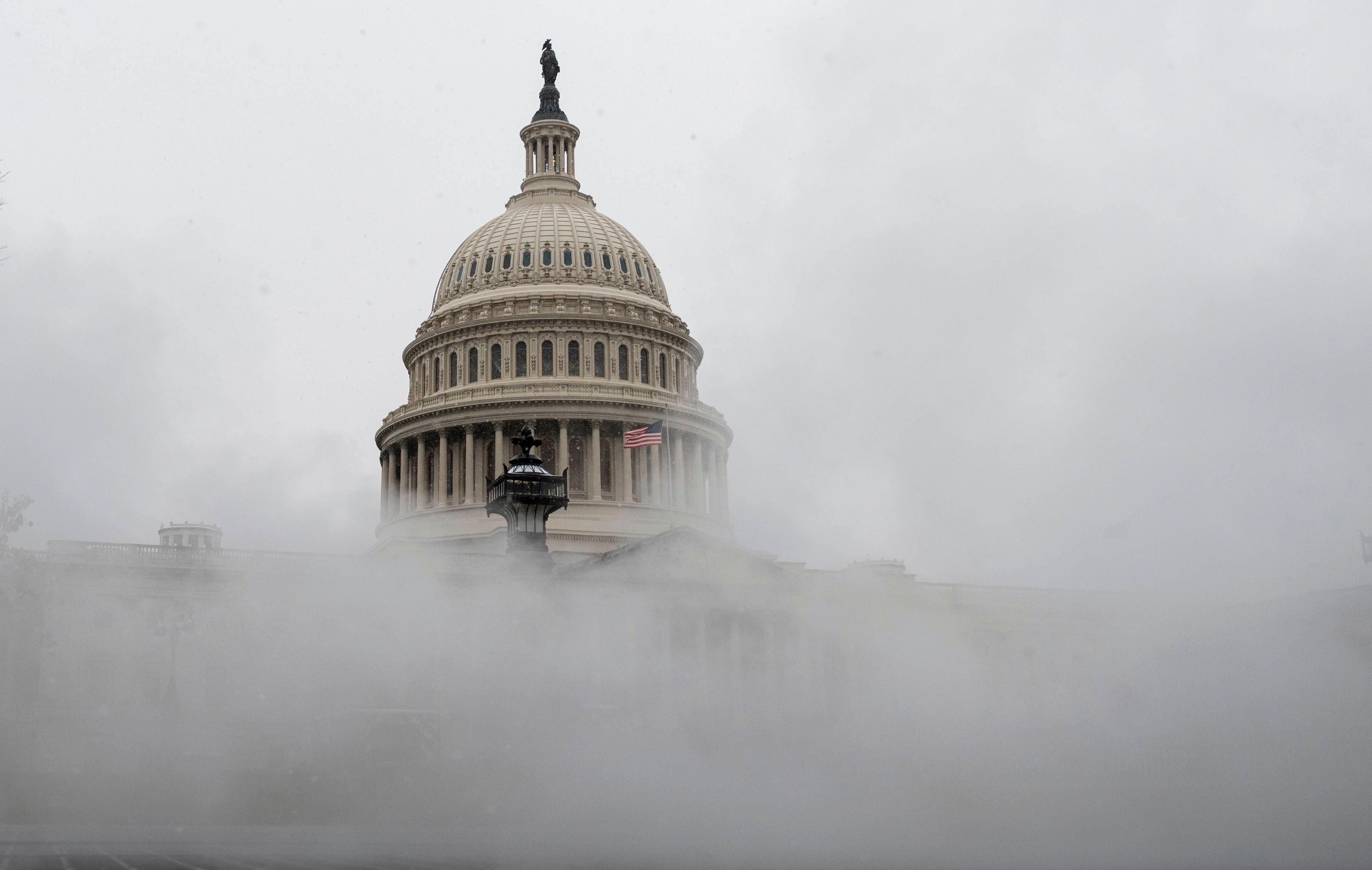 The US Capitol is enveloped with mist on Wednesday as much of the East Coast braces for snow
