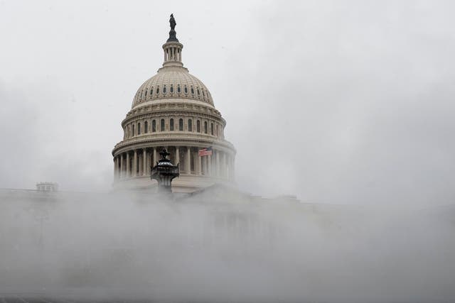 The US Capitol is enveloped with mist on Wednesday as much of the East Coast braces for snow