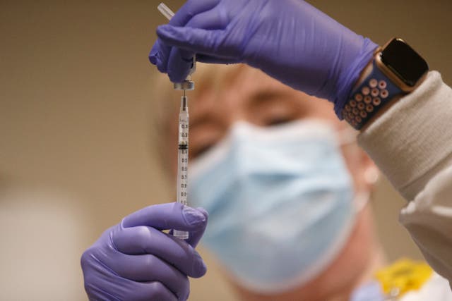 <p>Tami Jeffries, R.N., prepares the first locally-available dose of the Pfizer-BioNTech COVID-19 vaccine at Mary Washington Hospital in Fredericksburg, Va. on Tuesday, Dec. 15, 2020.&nbsp;</p>