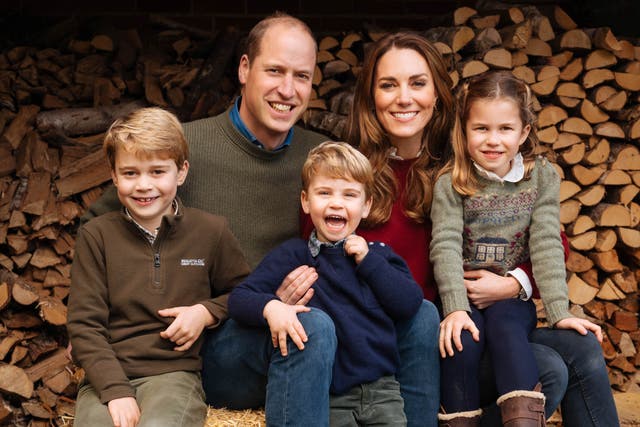 <p>Charlotte poses alongside her parents and siblings for their annual festive photo</p>