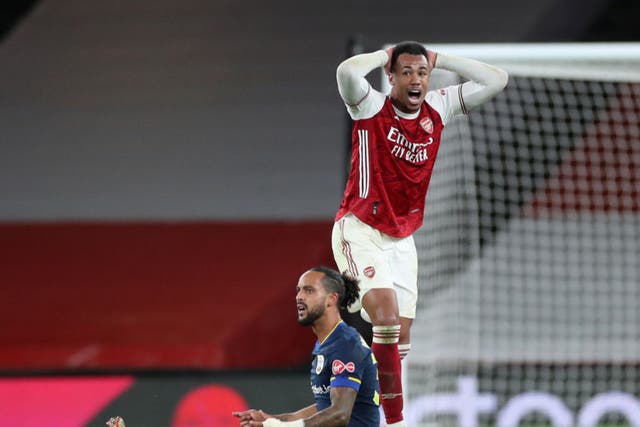 <p>Gabriel reacts after fouling Theo Walcott to earn himself a second booking</p>
