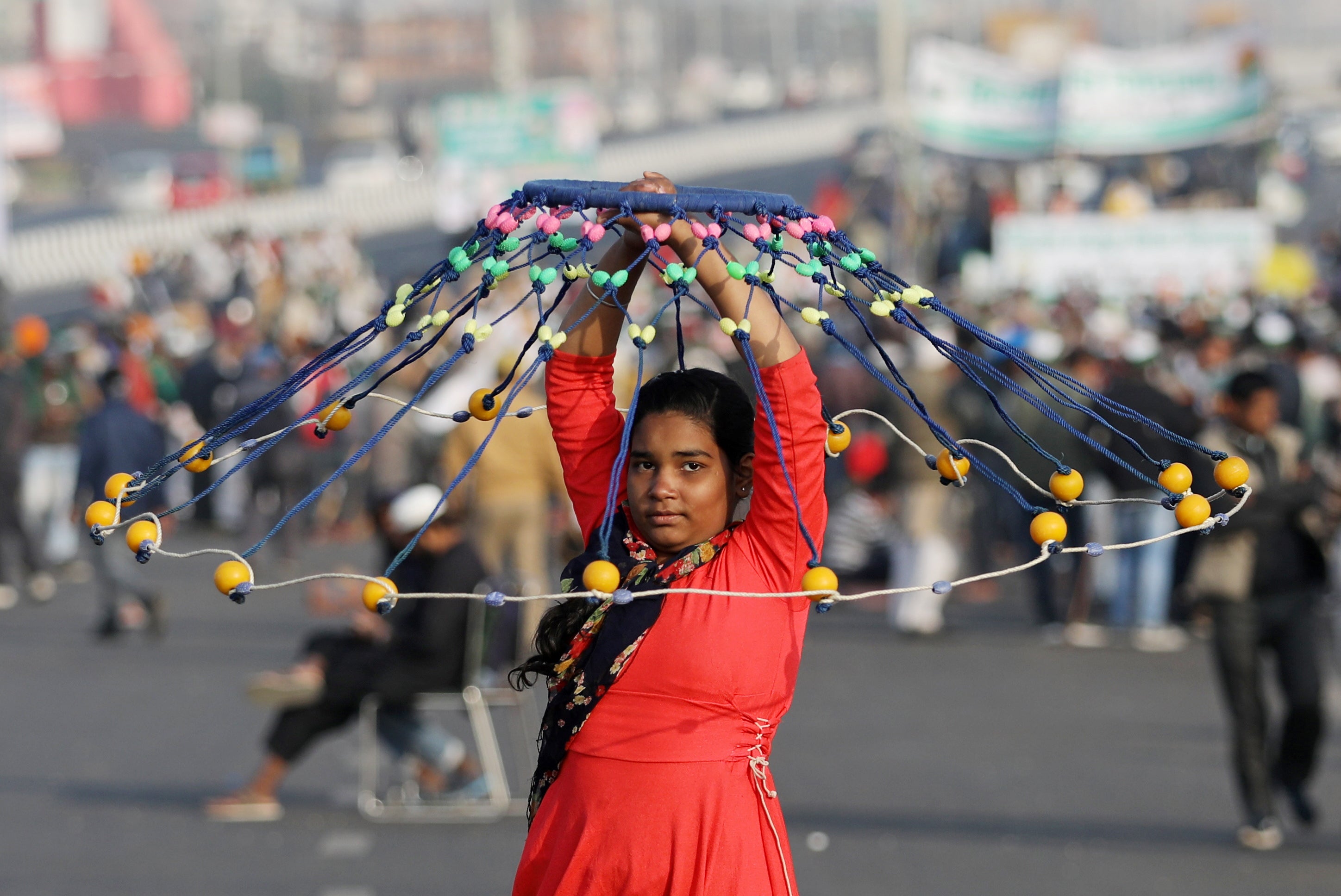 A girl performs the Gatka, a traditional form of martial art, as farmers take part in a protest against farm bills passed by India's parliament at Delhi-Uttar Pradesh border on the outskirts of Delhi, India