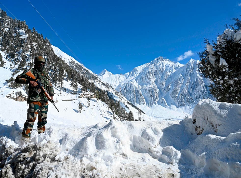 An Indian army soldier stands on a snow covered road after snowfall near Zojila mountain pass that connects Srinagar to the union territory of Ladakh, bordering China on November 26, 2020. An Indian army soldier stands on a snow covered road after snowfall near Zojila mountain pass that connects Srinagar to the union territory of Ladakh, bordering China. (Photo by TAUSEEF MUSTAFA/AFP via Getty Images)