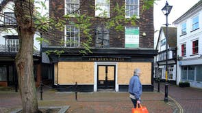 People walk through Ashford in Kent as Tier 3 restrictions are planned for large areas of England