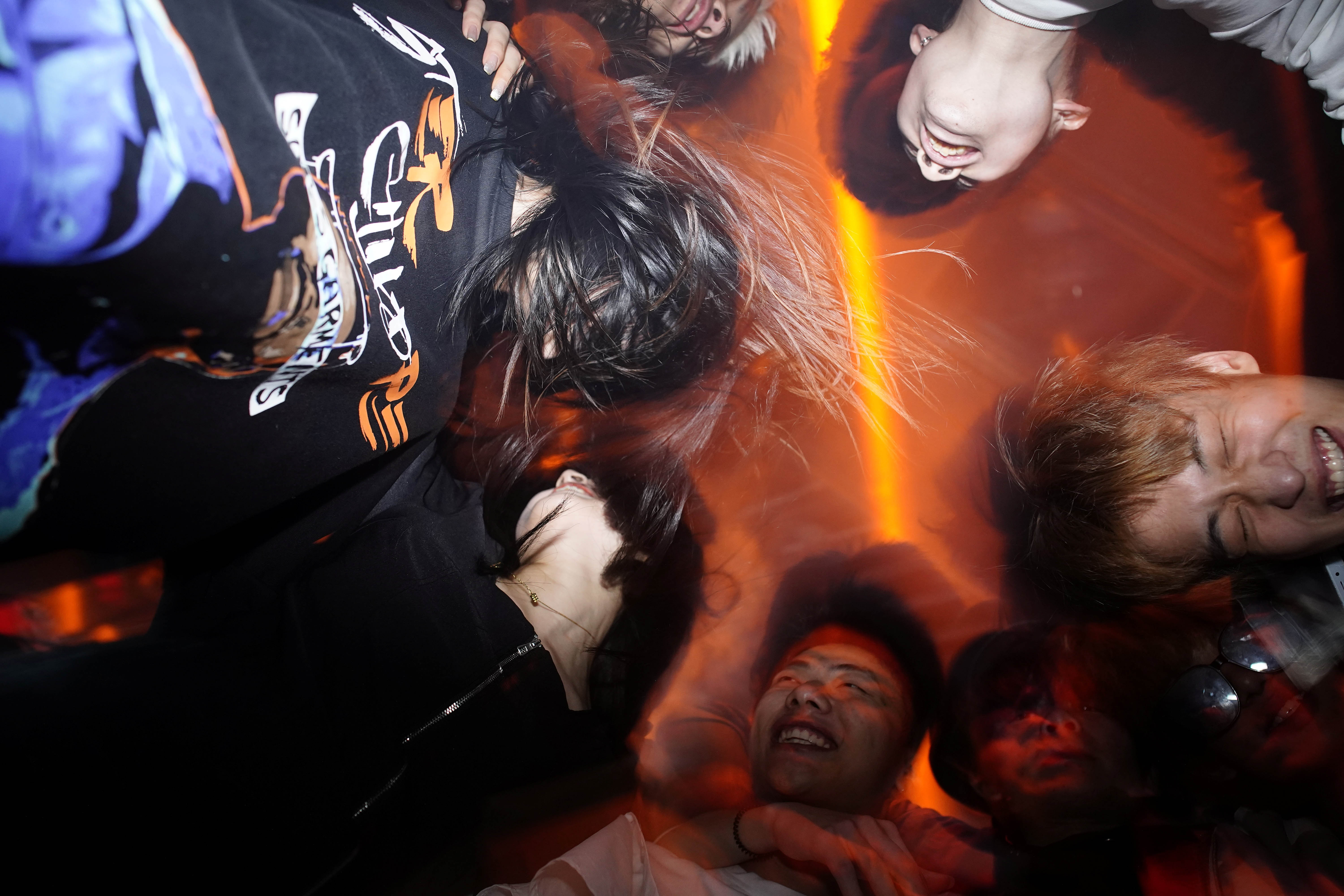 Revellers dance at a nightclub almost a year after the global outbreak of coronavirus in Wuhan, China