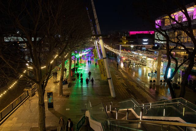 A view of people walking along Southbank lit with Christmas Lights during Tier 3 of the Covid-19 Pandemic Lockdown on 17 December 2020 in London.