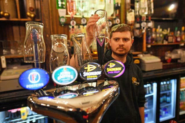David Morgan, supervisor at The Borough pub in Cardiff, puts glasses on top of the beer taps ahead of closing for two weeks as pubs, bars, restaurants and cafes are forced to stop selling alcohol and shut by 6pm as part in Wales’s coronavirus restrictions that came into force on Friday 4 December. 