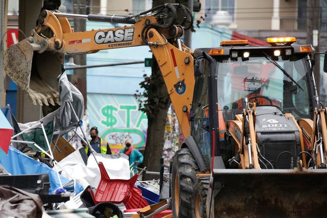 Workers use a bulldozer to remove remaining items from an encampment outside the Seattle Police Department’s East Precinct after police cleared the Capitol Hill Occupied Protest (CHOP) in Seattle, Washington on 1 July, 2020
