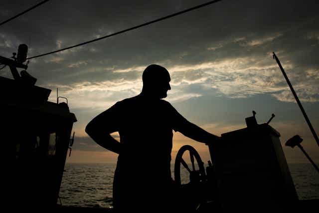 A crew member stands on deck as he heads out to fish for flatfish such as skate and Dover Sole in the English Channel from a Hastings fishing boat on 10 August, 2020 in Hastings, England. A fisheries dispute has become a major sticking point in Brexit negotiations.