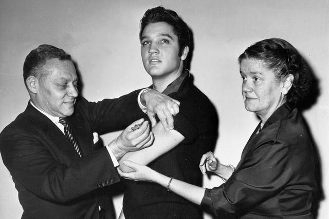 <p>Elvis Presley, then 21 years old, gets a polio vaccine</p>
