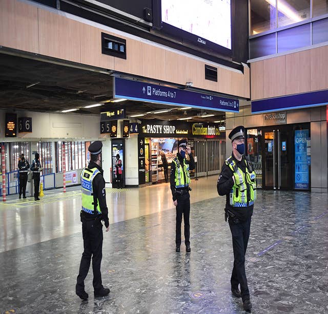 Police officers at Euston Station, London, with more being deployed to enforce travel rules at London’s stations