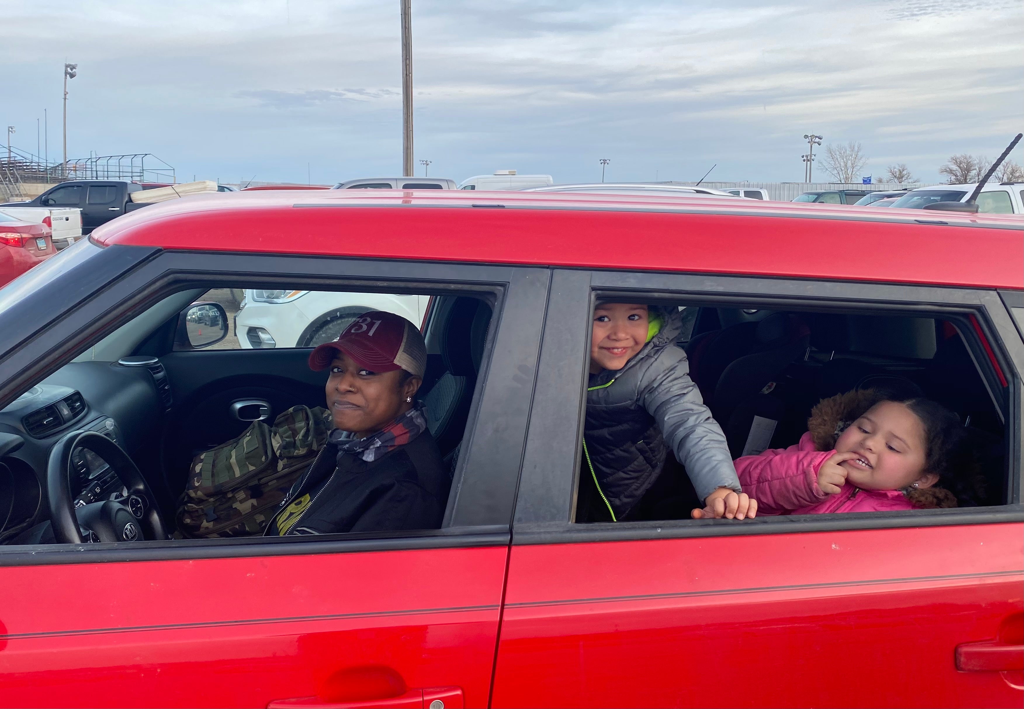 Deidra Heid, 29, and her two children, wait in line at a mobile food bank in Williston, North Dakota