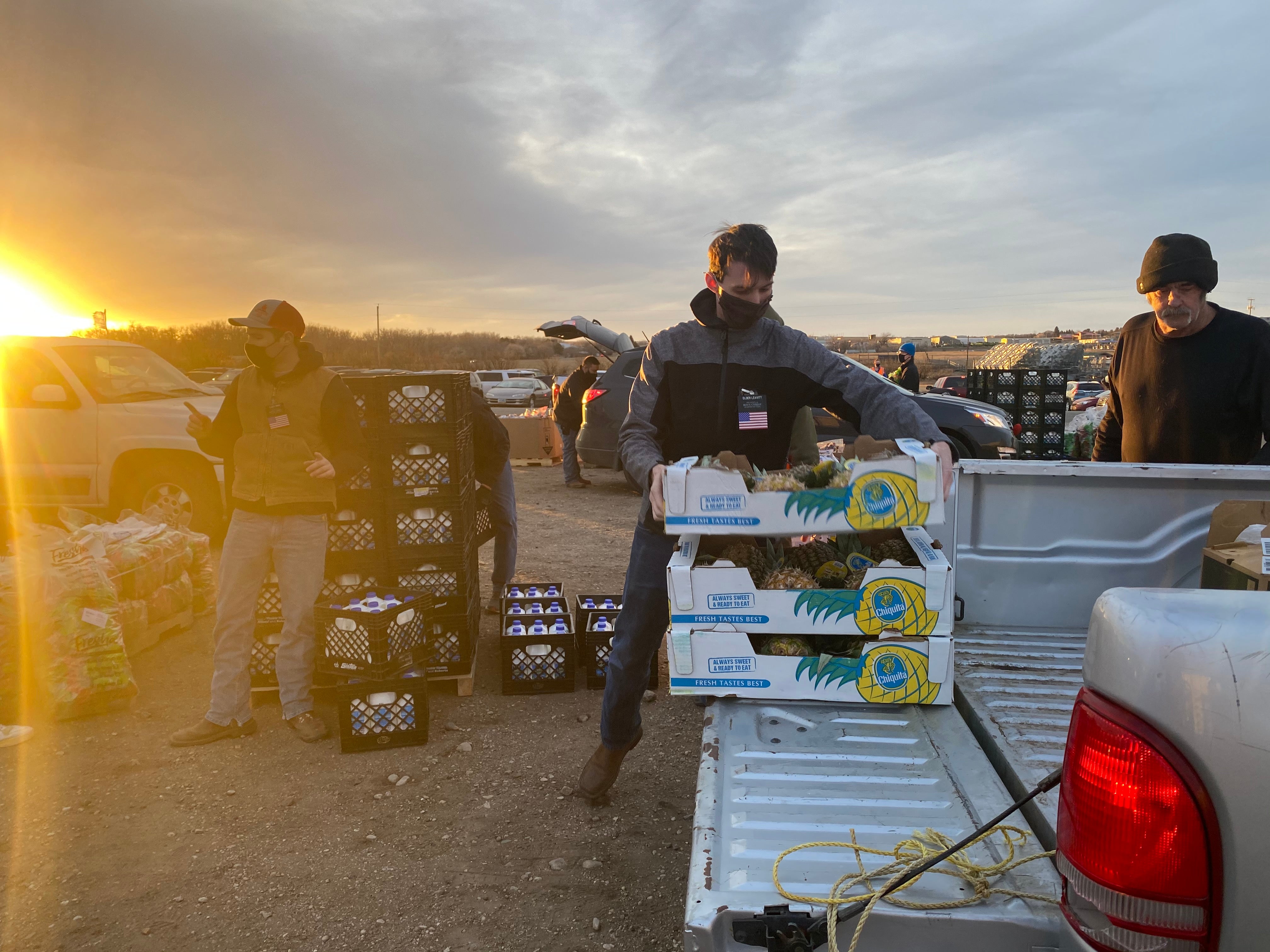 A volunteer loads food onto a truck at a mobile food pantry run by the Great Plains Food Bank in Williston, North Dakota