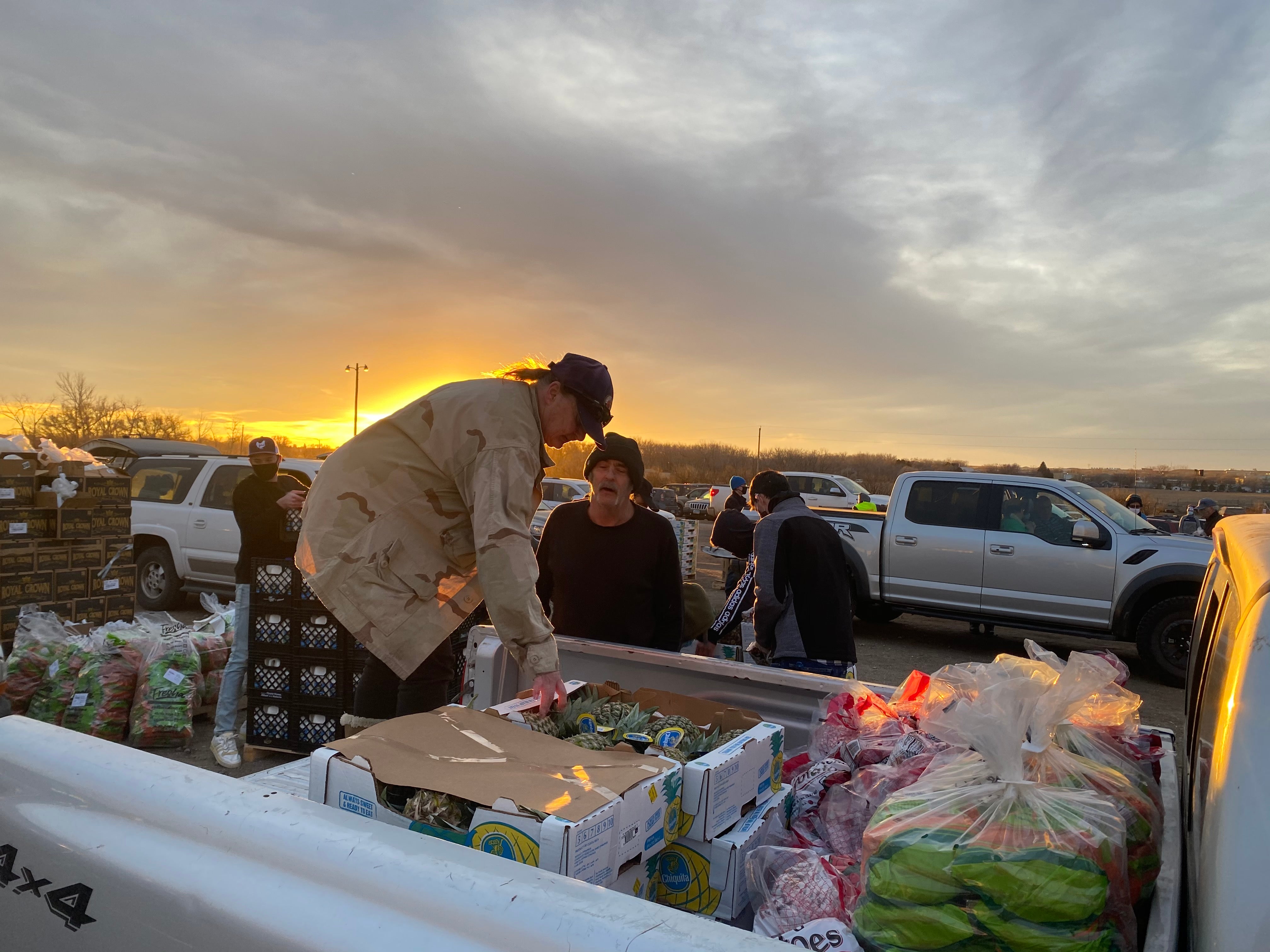 Barbara Doughtie loads boxes of food onto her truck at a mobile food bank in Williston, North Dakota